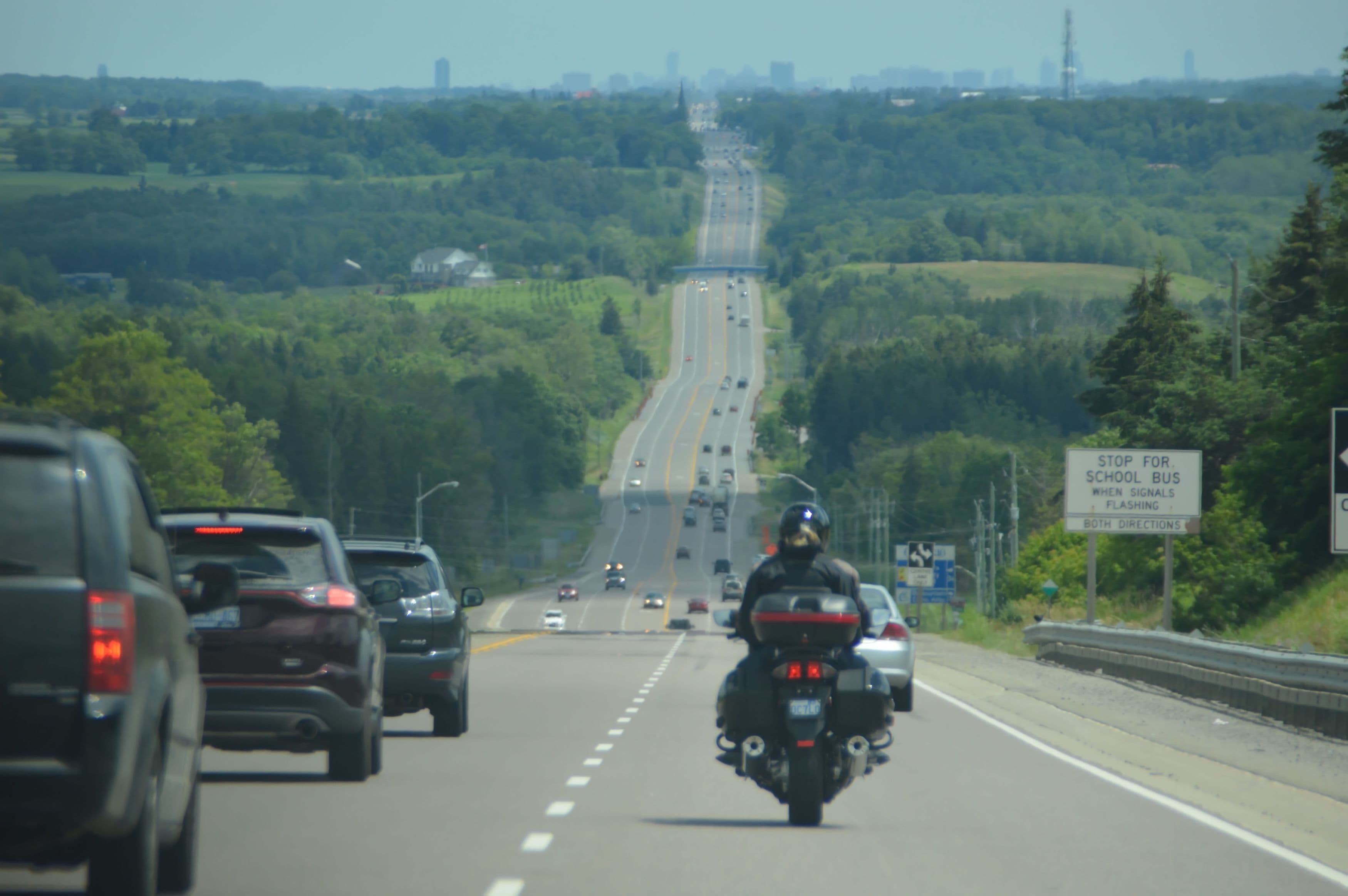 A motorcyclist in traffic, staying safely in their lane as lane splitting is not legal in Oregon.